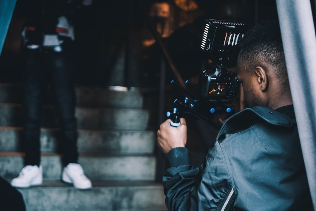 Camera operator adjusting framing on professional broadcast camera